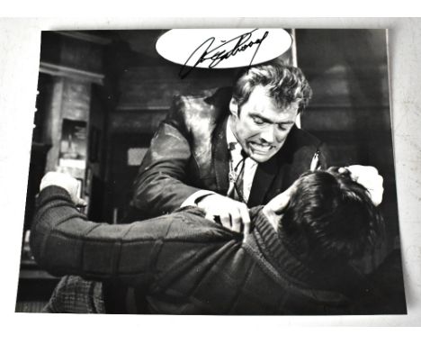 CLINT EASTWOOD; a black and white photograph bearing his signature, 21 x 25.5cm.We have not authenticated this signature, ple