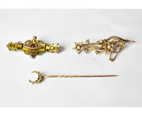 A yellow metal floral spray brooch set with seed pearls, an Edwardian 9ct bar brooch set with single garnet and seed pearls a