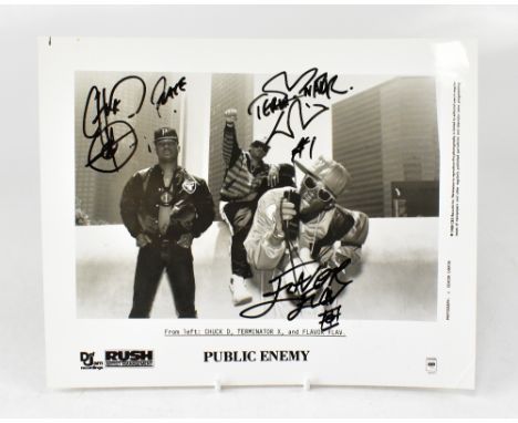 PUBLIC ENEMY; a black and white photograph bearing the signatures of the three band members, along with a promotional folder 