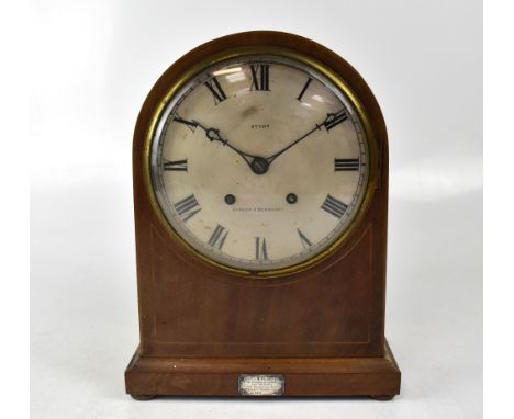 A George V mahogany arched-top mantel clock with boxwood stringing, the silvered dial set with Roman numerals and inscribed '