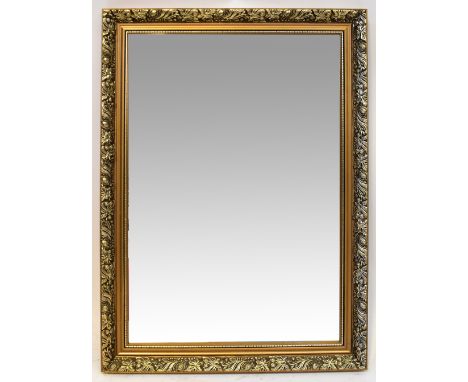 A gilt framed rectangular wall mirror with bevelled glass plate, the frame with pomegranates and leaves, 88 x 62cm.