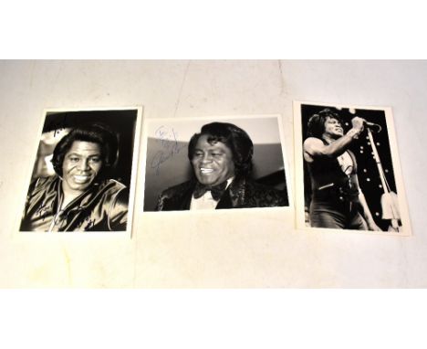 JAMES BROWN; three black and white photographs, each bearing the star's signature (3).We have not authenticated these signatu