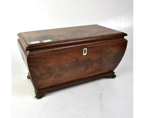 A 19th century mahogany tea caddy of tapering form, the lid with fitted interior containing two hinged boxes and a cut glass 