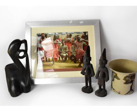 A pair of Nigerian carved wooden figures, together with a further carved stylised African figure of a woman, a Newton Pottery