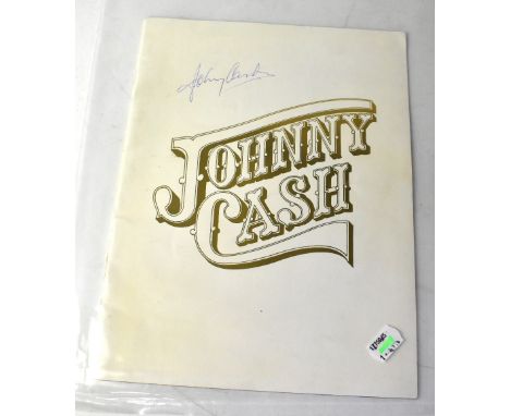 JOHNNY CASH; a tour programme bearing the star's signature and that of June Carter Cash.We have not authenticated these signa