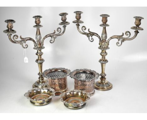 A pair of Victorian plated three-branch candelabra, a pair of bottle coasters with lattice work design and grape and vine to 