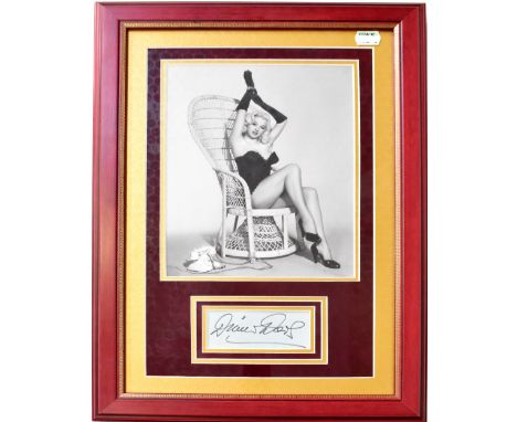DIANA DORS; a black and white photograph of the star with an autograph album page mounted below bearing the star's autograph,