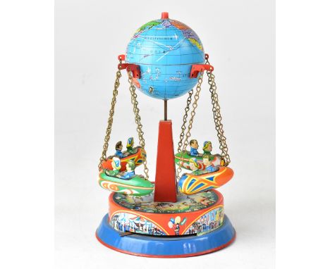 A vintage tin plate toy modelled as a fairground ride, with world globe to the top and four carriages in the form of spacecra