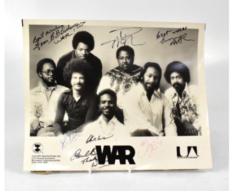 WAR; a promotional black and white photograph bearing the band's signatures, along with an album (2).We have not authenticate