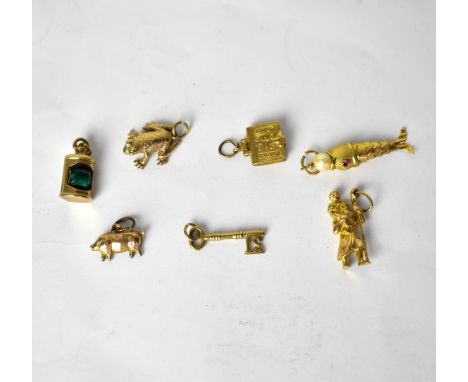 Seven 9ct yellow and rose gold bracelet charms, comprising a pig, a reticulated fish with pearl in mouth and small ruby set e