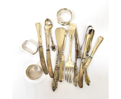 A small mixed lot of hallmarked silver items, comprising three napkin rings, a set of four silver-handled butter knives, a si
