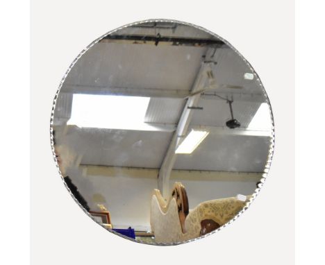 A 1930s circular wall mirror, with bevelled wavy edge, diameter 66cm.