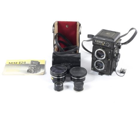 A Yashica Mat-124G 6x6 medium format TLR camera. With a 80mm 1:3.5 Yashinon taking lens, together with telephoto and wide ang