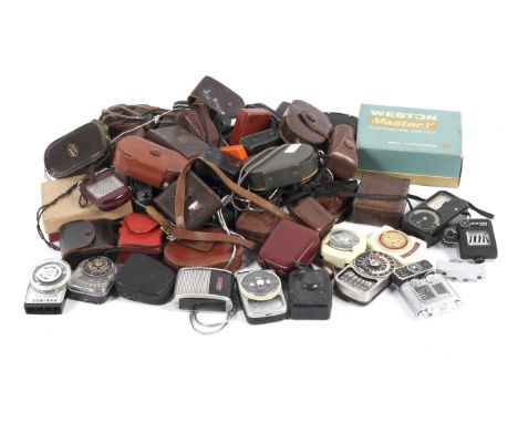 A collection of light meters. Including hand held and shoe mount examples from makers such as Asahi Pentax, Weston, Gossen, F