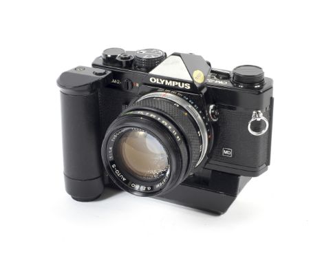 An Olympus OM-2N 35mm SLR camera. Black, with a 50mm 1:1.4 G.Zuiko Auto-S lens and an Olympus Winder 2