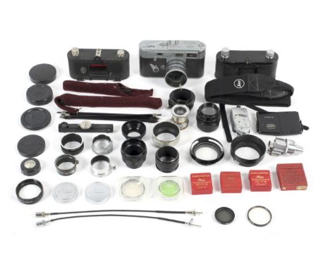 A collection of Leitz Leica accessories. To include a black rangefinder, an adjustable viewfinder, a Summitar folding lens ho