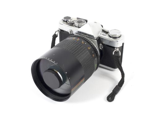 An Olympus OM-1 35mm SLR camera. With a 500mm Makinon mirror lens