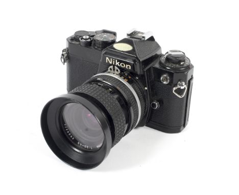 A black Nikon FE 35mm SLR camera. With a 35-70mm 1:3.3-4.5 Zoom-Nikkor lens