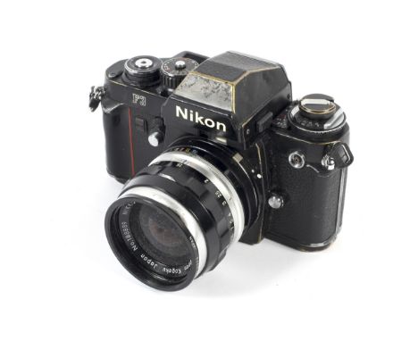 A black Nikon F3 35mm eye level SLR camera. With a 35mm 1:2.8 Nikkor-S lens