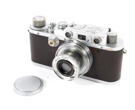 A Leica III 35mm rangefinder camera, chrome, 1937. With a 50mm 1:3.5 Leitz Elmar lens. Camera body serial number 253574.