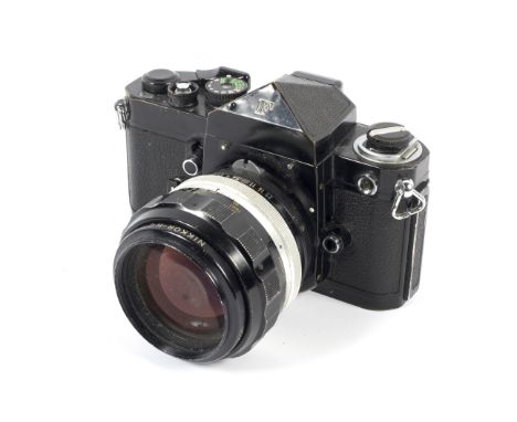 A black Nikon F 35mm SLR eye level camera. With an 85mm 1:1.8 Nikkor-H.C lens