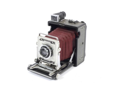A Graflex Century Graphic 2x3 baby press camera. With red bellows and a 105mm 1:5.6 Symmar lens