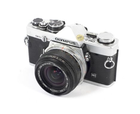 An Olympus OM-2N 35mm SLR camera with a 21mm 1:3.5 Zuiko Auto-W lens Condition Report: Shutter: Shutter is not firing. Unable