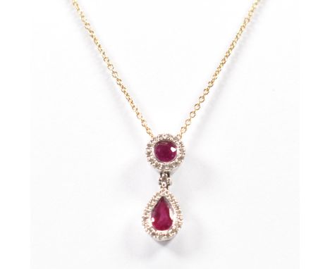 A 18ct gold ruby and diamond pendant necklace. The pendant set with a round and pear cut ruby with a halo of diamonds on a fi