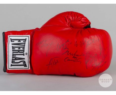 A red autographed Everlast boxing glove, autographed by nine boxers including Muhamad Ali, Ken Norton, Lennox Lewis, Evander 