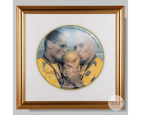 A large colour photographic print of Rivaldo and Ronaldo of Brazil with the trophy from the 2002 World Cup, signed in black p