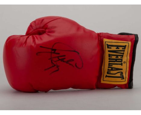 A red Everlast boxing glove signed by Larry Holmes.