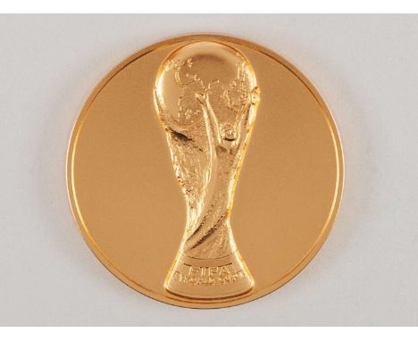 Yellow-metal FIFA 1990 World Cup medal, designed by Huguenin, obverse with Jules Rimet trophy in relief and lettered&nbsp;FIF