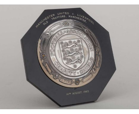 George Best silver-mounted and black bakelite 1965 Charity Shield plaque, inscribed MANCHESTER UNITED v. LIVERPOOL OLD TRAFFO