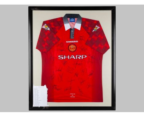 A red autographed Manchester United short-sleeved shirt, 1996-97, the front of the shirt bearing twenty-two player autographs