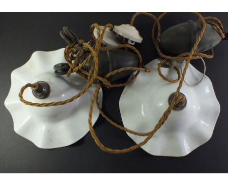A pair of Edwardian opaque glass frilled light fittings on adjustable weighted cords 