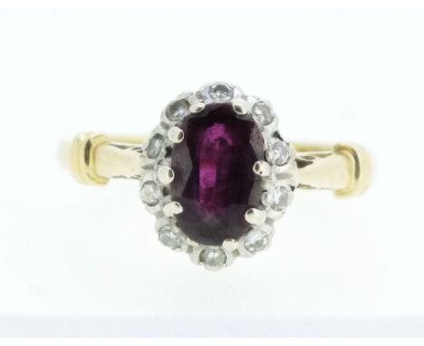 An 18 carat gold ruby and diamond cluster ring, size K 