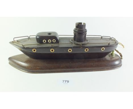 A 1920?s table lamp base in the form a wooden ship with ivory porthole windows, 35cm long 