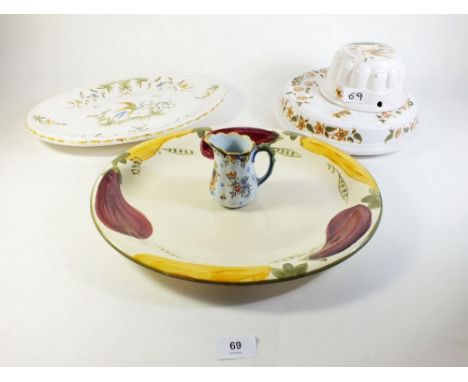 A Poole pottery serving dish and four items of Faience pottery 