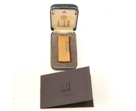 Dunhill - a gold-plated cigarette lighter, engine turned in the Florentine design, 63mm, with box and suedette pouch, service