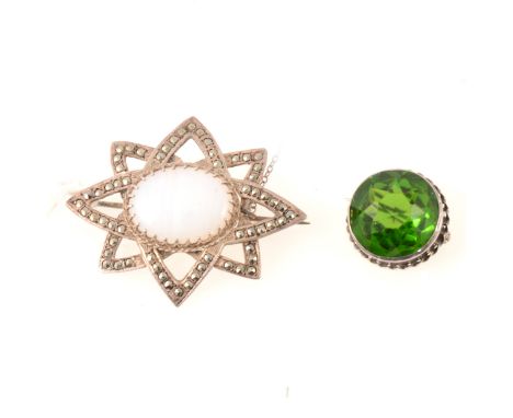 A silver and green paste brooch by Charles Horner, Chester 1914, 22mm, an oval white metal brooch with a pale oval cabochon a