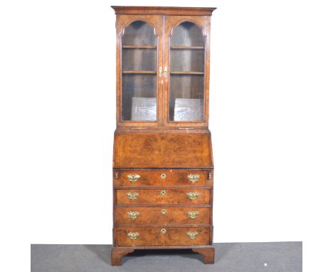 George I style walnut bureau bookcase, early 20th Century, cavetto moulded cornice, two arched glazed panelled doors, enclosi