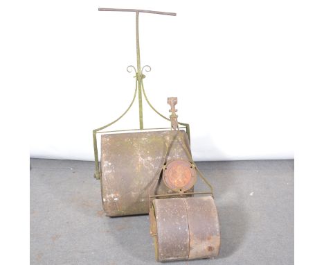 Large cast iron garden roller, width 57cm, diameter 57cm, wrought iron handle, and another smaller.