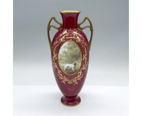 A beautiful burgundy glazed double handled base decorated with intricate hand painted gilt designs, and an oval panel of an E