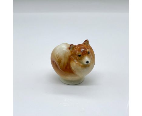 Hand painted porcelain figure of a small toy dog in a light brown glaze. Doulton backstamp. Issued: c. 1923-1946Dimensions: 1