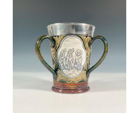 A glazed stoneware three-handled cup with sterling silver mounted rim. Decorated with a beaded panel of three incised dogs, a
