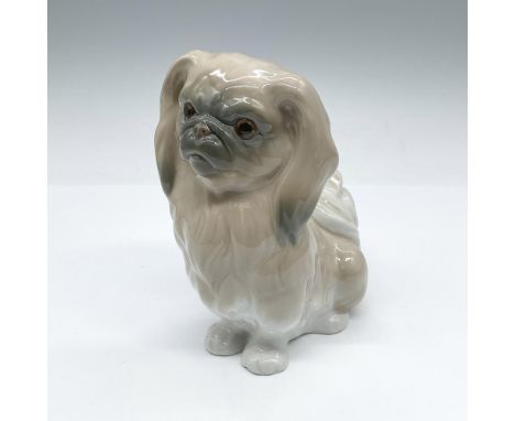 This glossy figurine depicts an adorable Pekinese dog sitting patiently. Light brown coloration. Lladro backstamp. Artist: Sa