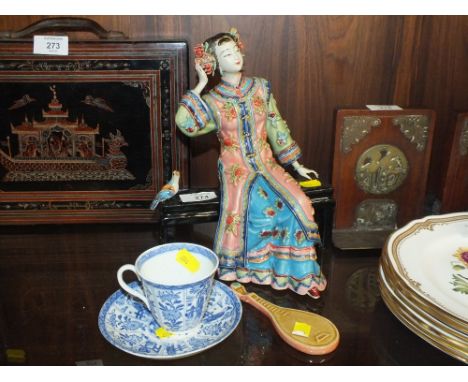 AN ORIENTAL CERAMIC FIGURE OF A SEATED LADY TOGETHER WITH AN ORIENTAL BLUE AND WHITE CUP AND SAUCER ETC