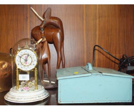 A CERAMIC GLASS DOMED MANTEL CLOCK TOGETHER WITH A SHOE BRUSH BOX AND A CARVED WOODEN FIGURE A/F