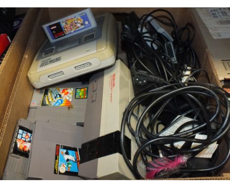 A TRAY OF VINTAGE GAMES CONSOLES AND ACCESSORIES TO INCLUDE A NES CONSOLE, SUPER NINTENDO ENTERTAINMENT SYSTEM ETC