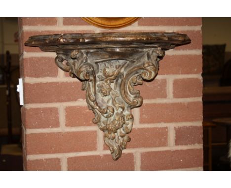AN ORNATE CERAMIC WALL BRACKET 